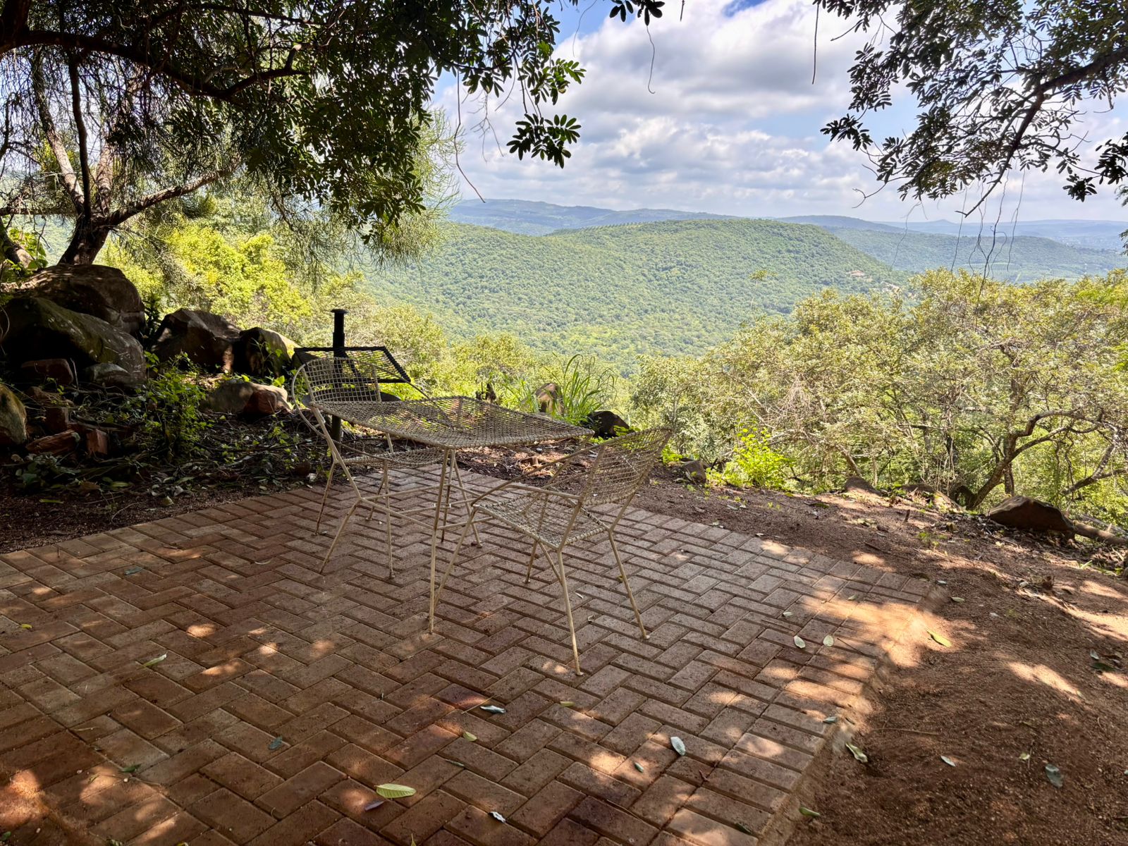 The terrace at Kanaan — set up for an evening gathering, with the Lowveld escarpment in the distance.