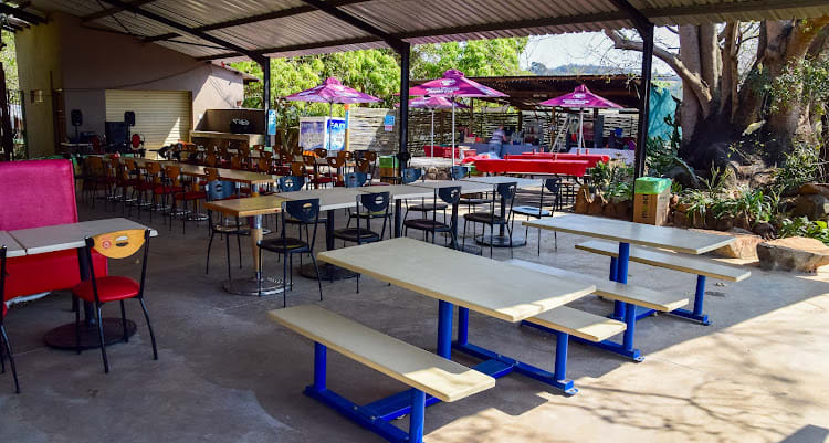 The Kanaan venue from the other side — bar tables, picnic seating and a games area, all under the covered roof.